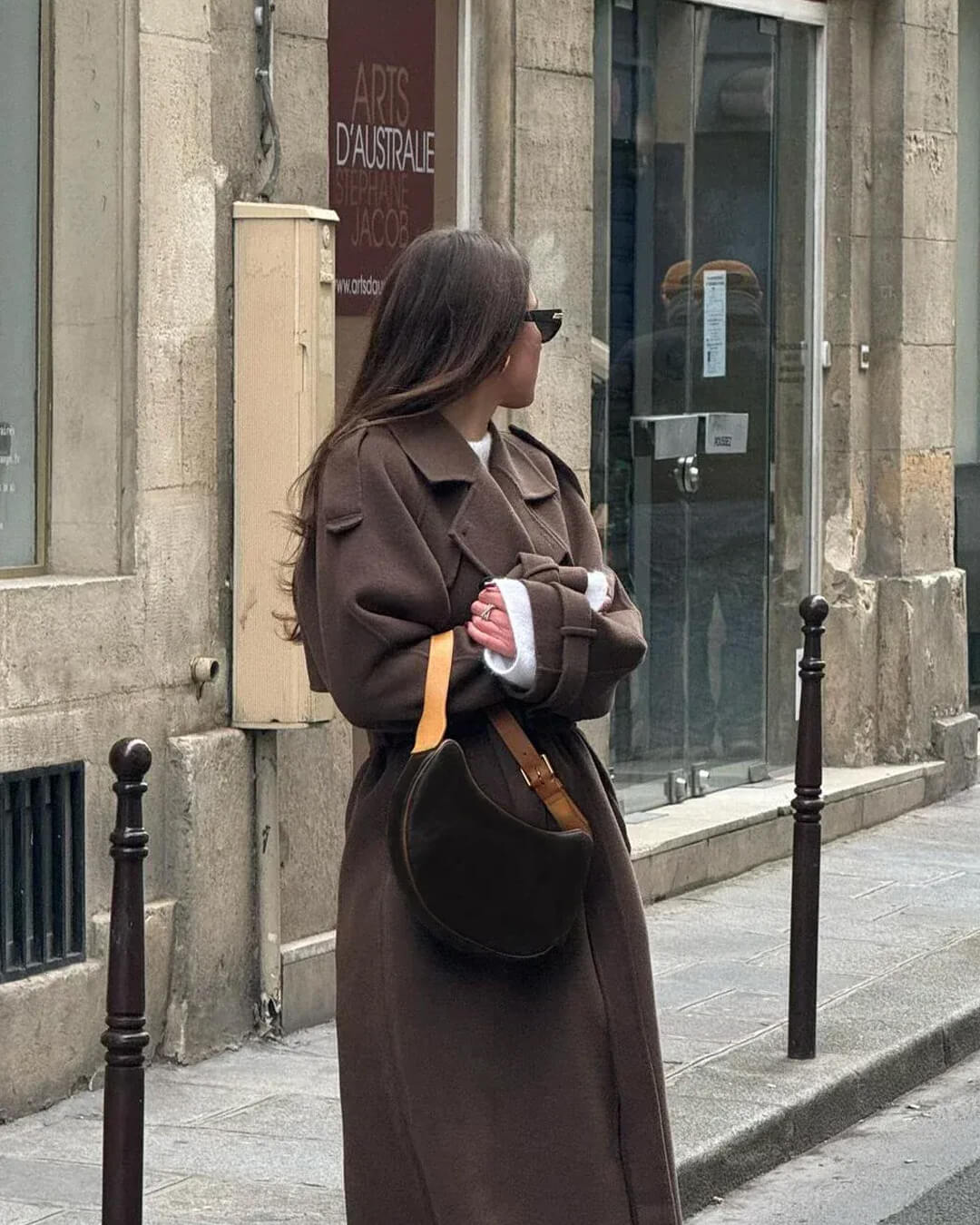 Longline Trench Coat in Brown - worn by a model outdoors, back view