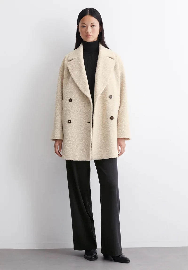 Petronille Double Breasted Pea Coat in Ivory Cream - worn by a model, front view