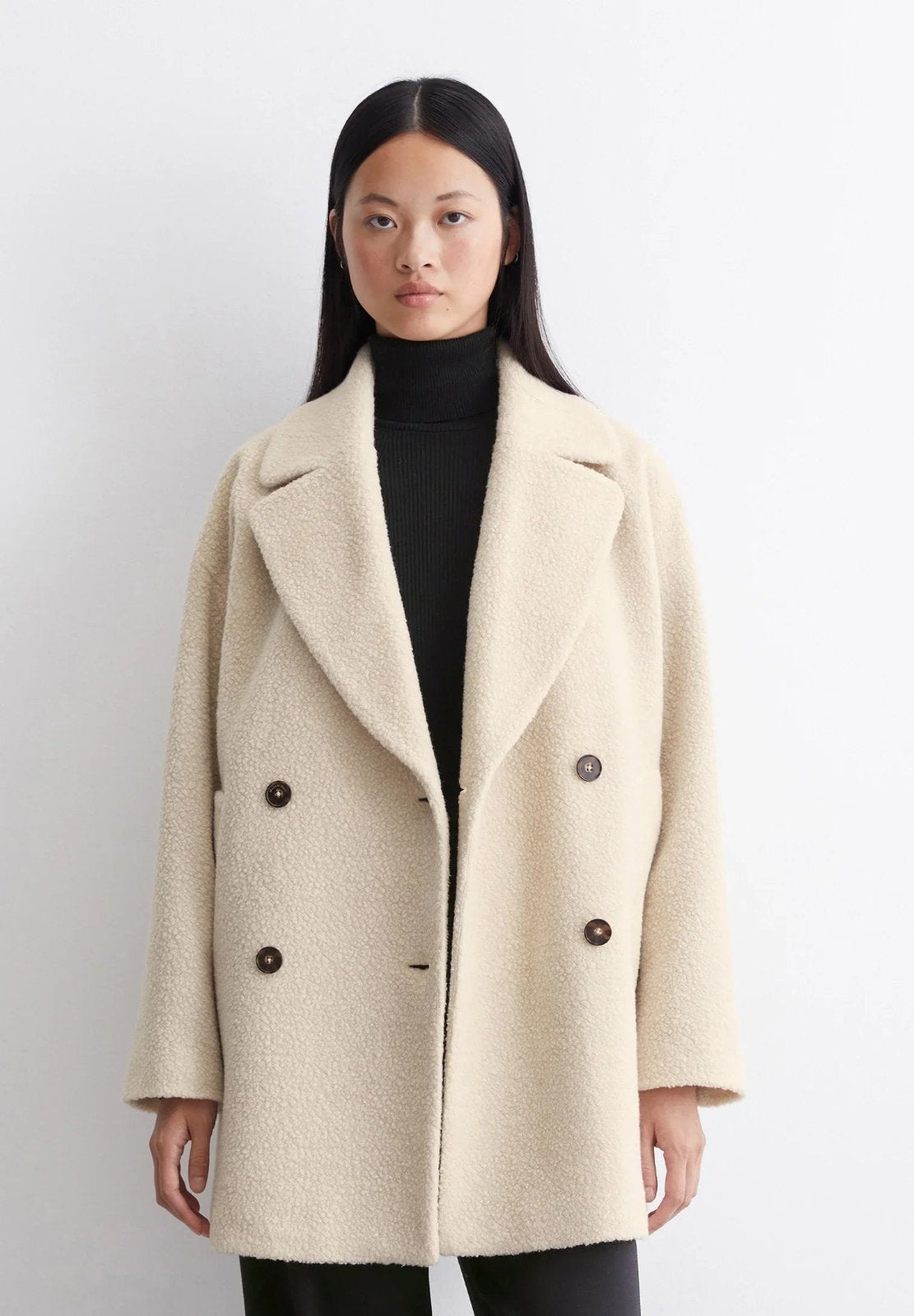 Petronille Double Breasted Pea Coat in Ivory Cream - worn by a model, front view