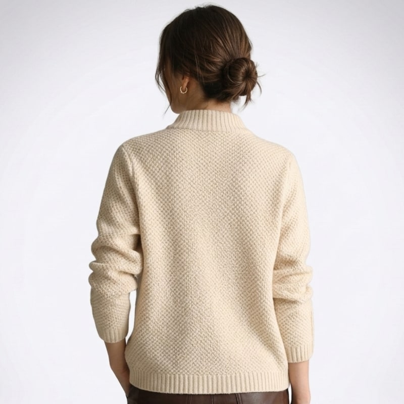 Back view of the beige knit cardigan showing the hip length and ribbed hem