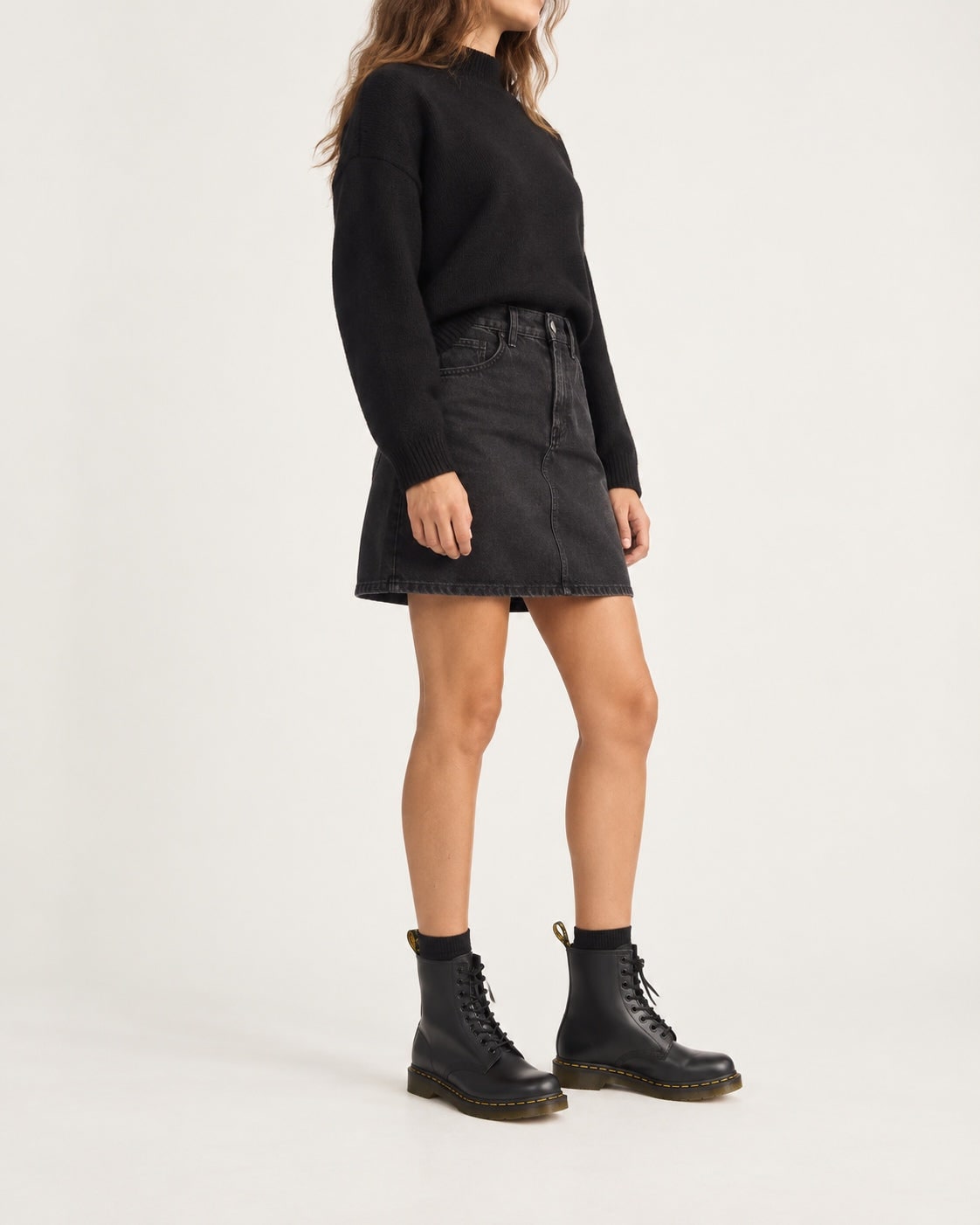Black lace-up boots worn with a denim skirt 5