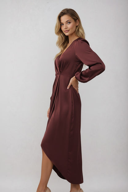 Burgundy wrap dress worn with hand on hip 2