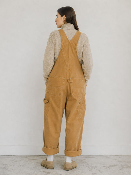 Beige canvas bib overalls, back view with cuffed legs 2