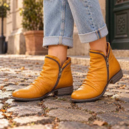 Yellow faux leather ankle boots on cobblestones 2