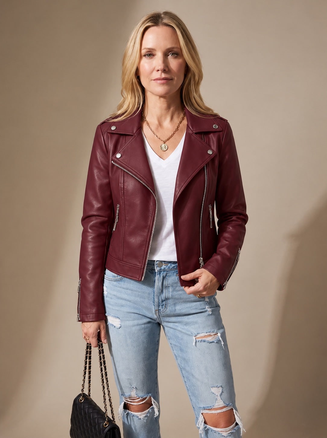 Burgundy faux leather moto jacket worn with a white tee 2