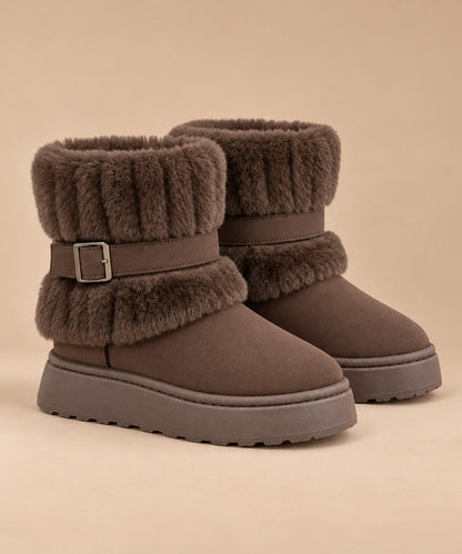 Coffee brown fur-trimmed slip-on snow boots with buckle strap, pair on a beige background 1