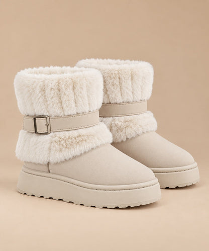 Beige fur-trimmed slip-on snow boots with buckle strap, pair on a beige background 6
