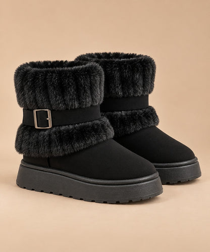 Black fur-trimmed slip-on snow boots with buckle strap, pair on a beige background 10