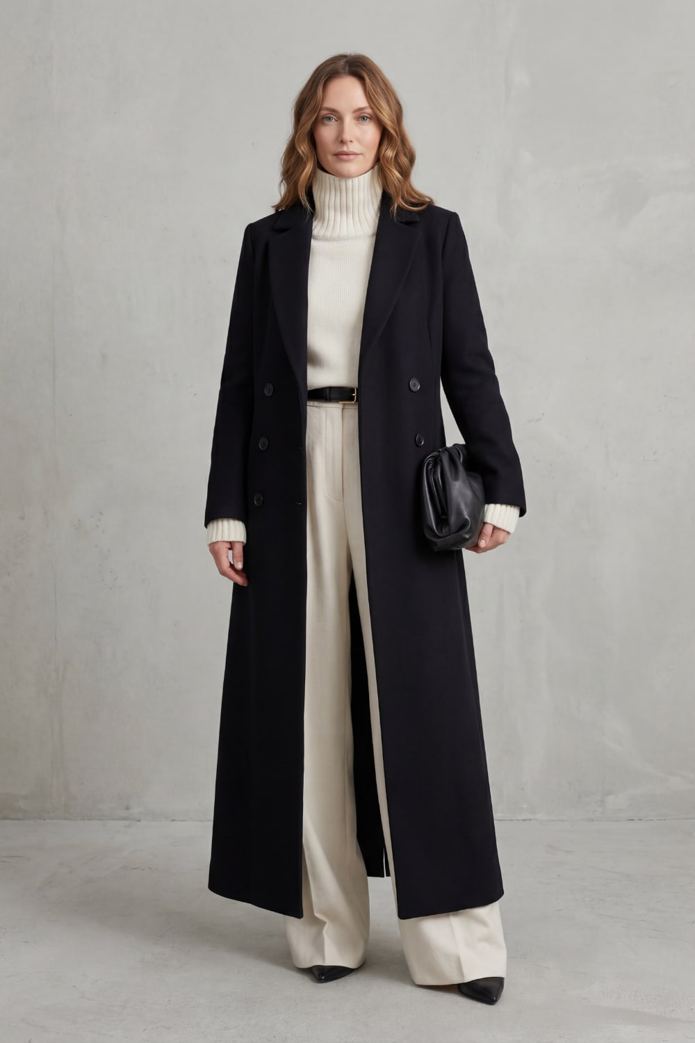 Black long tailored coat, front view with belt detail 2
